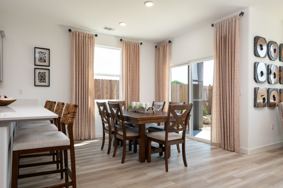 A dining room with a wood floor.