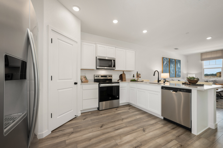 A kitchen with white cabinets.