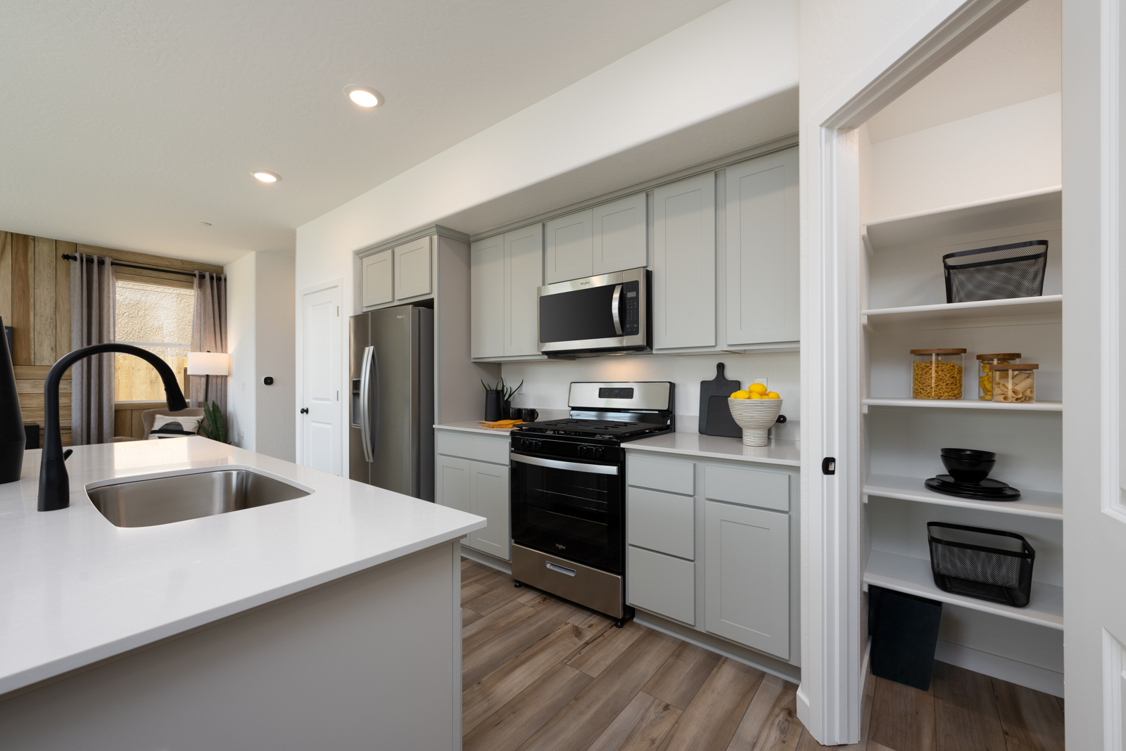 A kitchen with white cabinets.