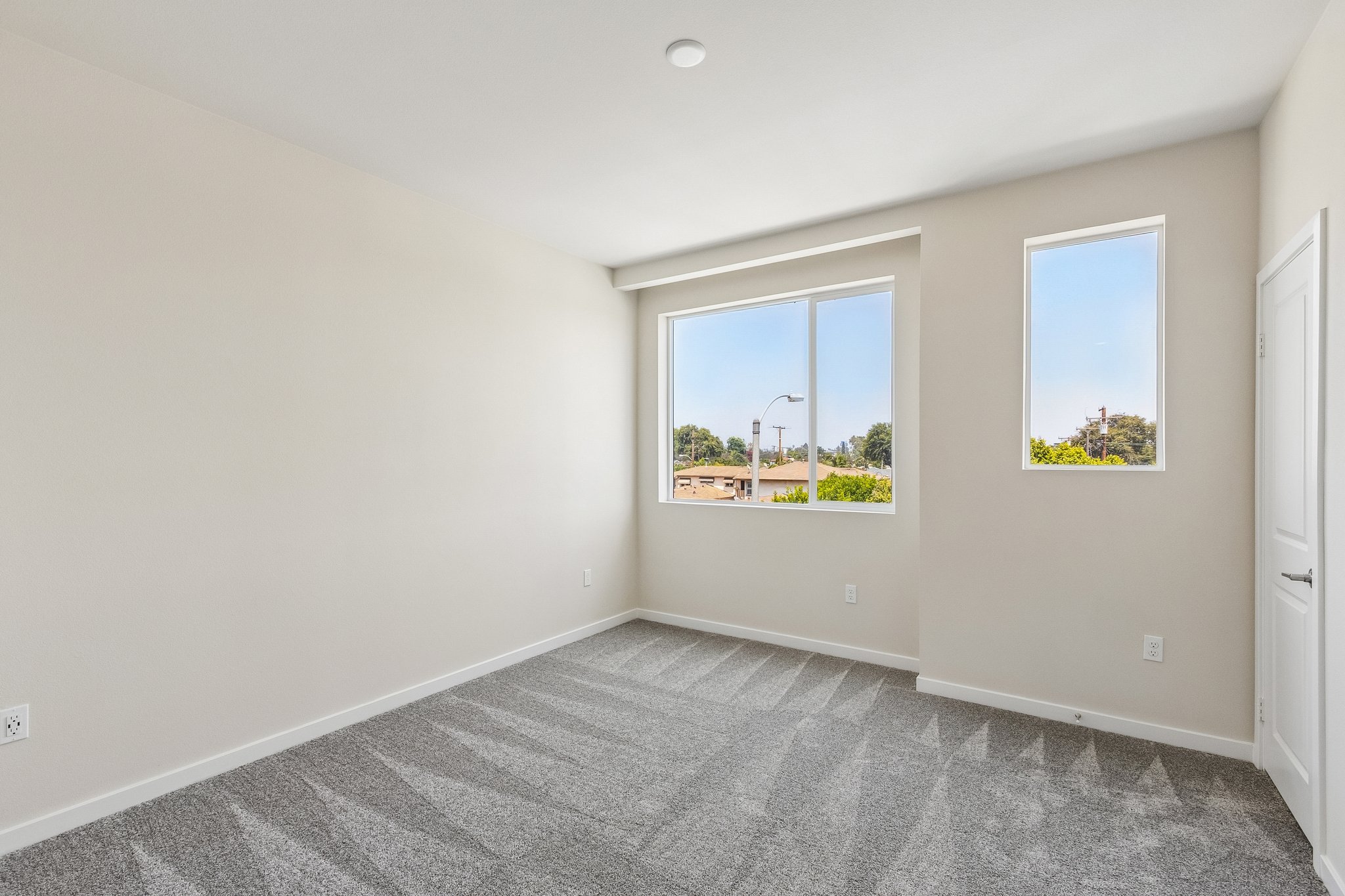 A room with a window and a rug.