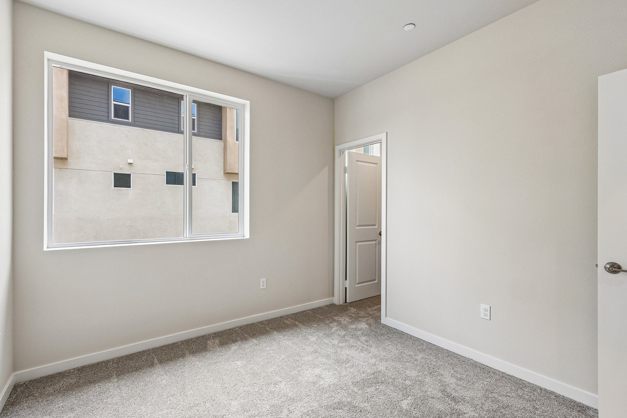 A room with a window and a door.