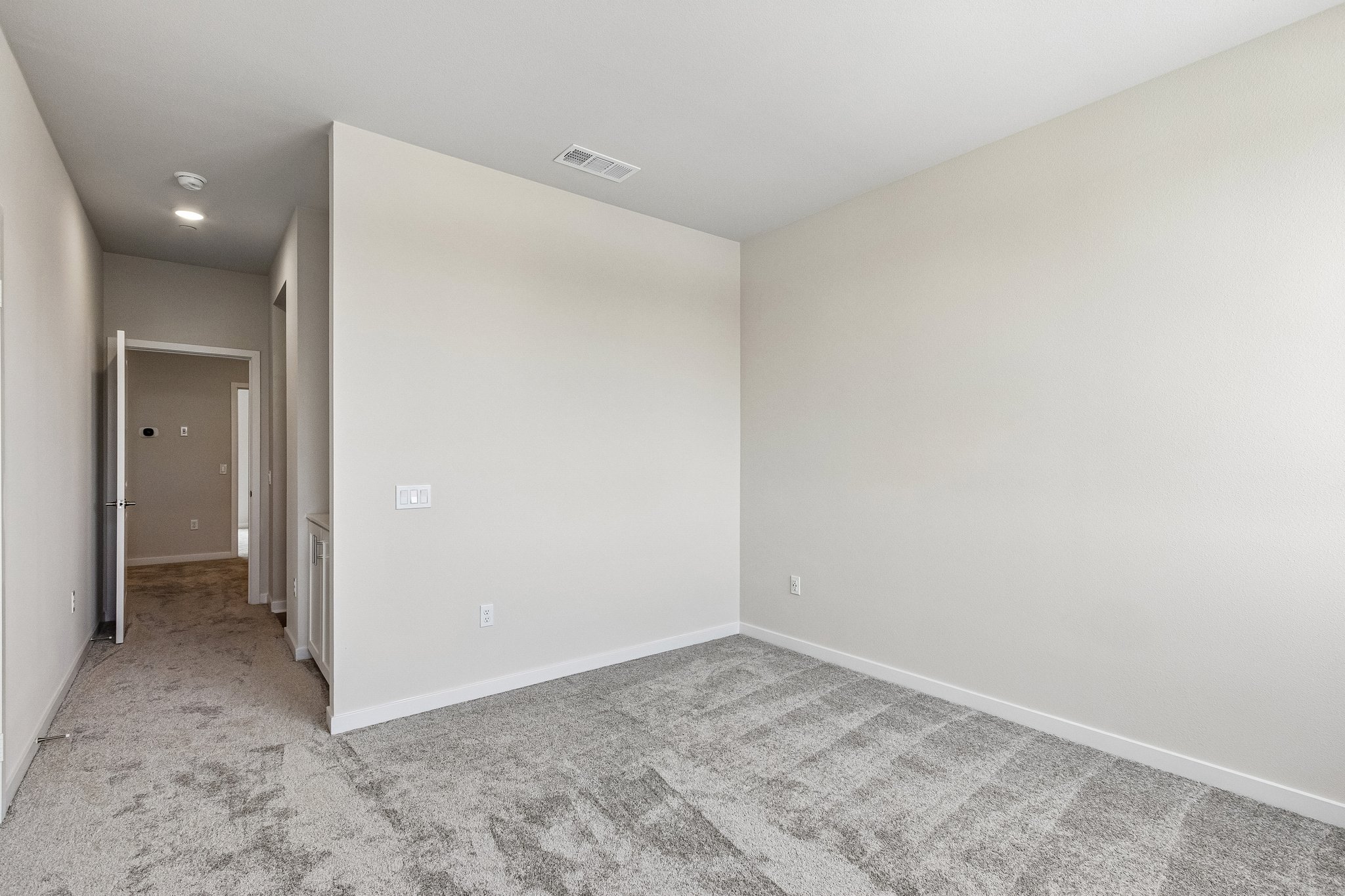 A hallway with white walls.