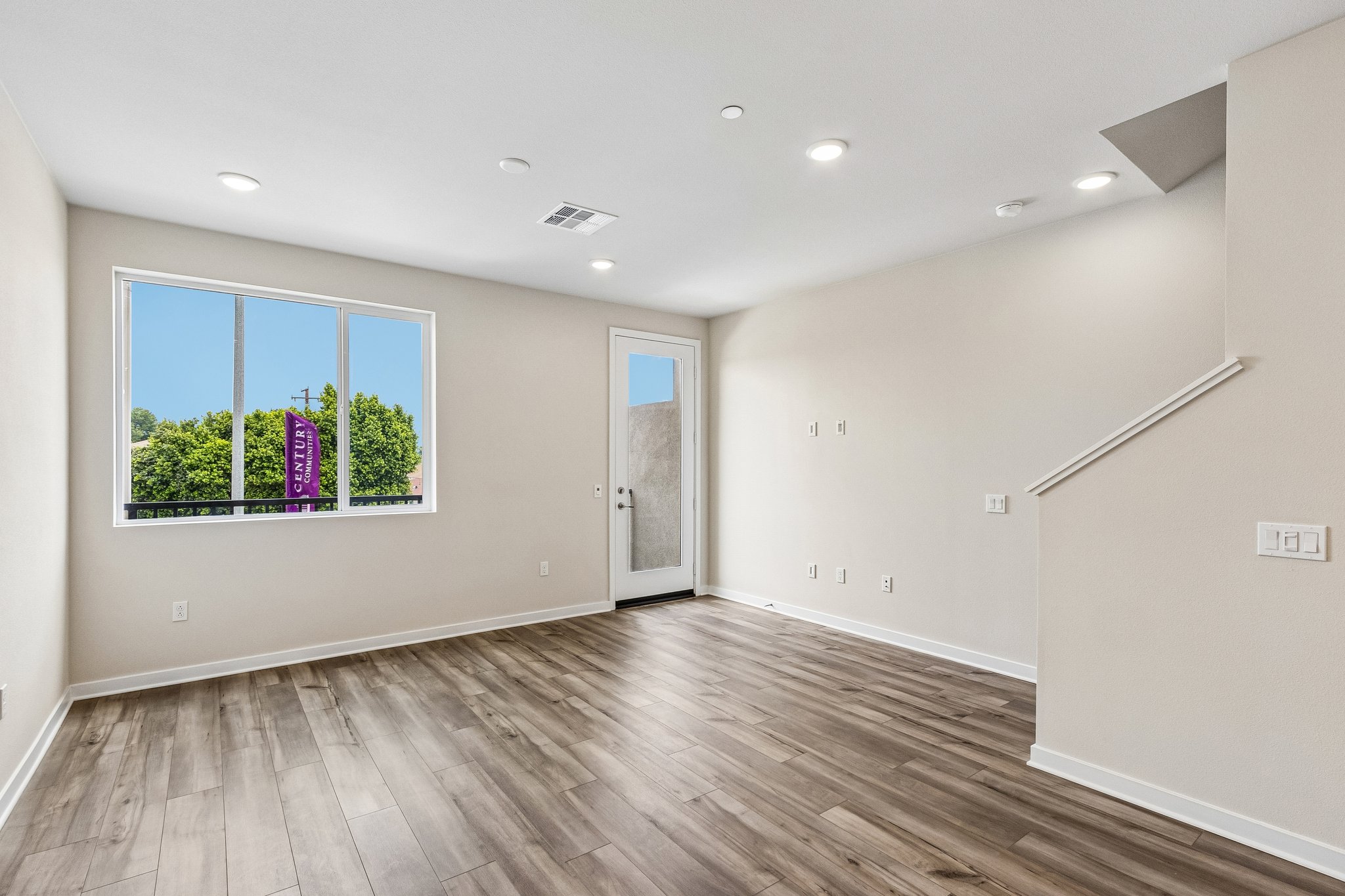 A room with a wood floor and a window with a wood floor.