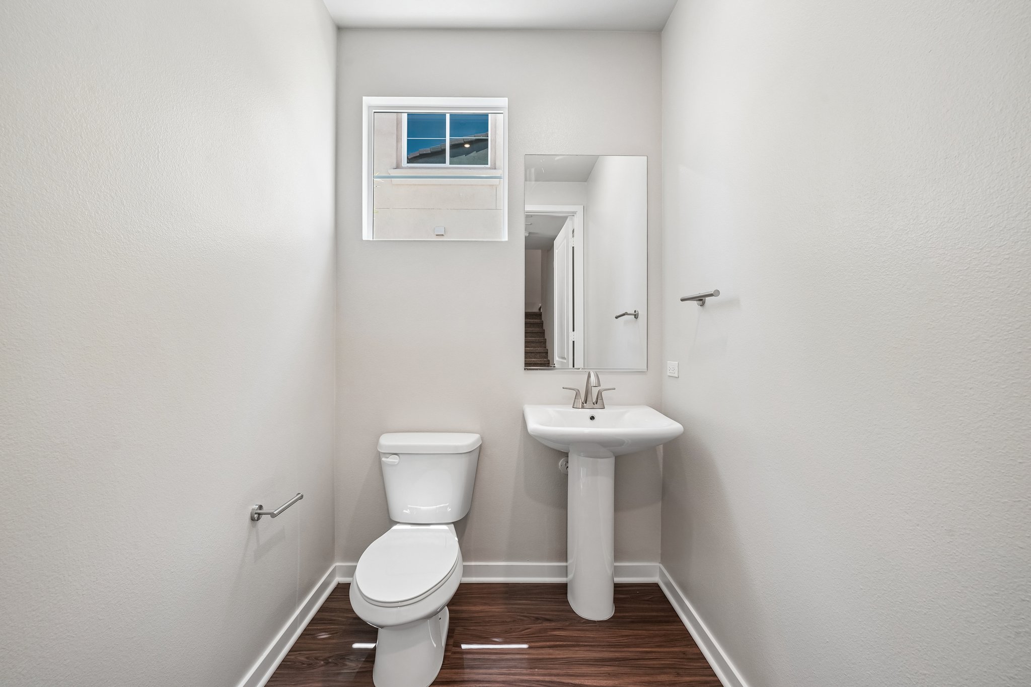 A bathroom with a toilet and sink.