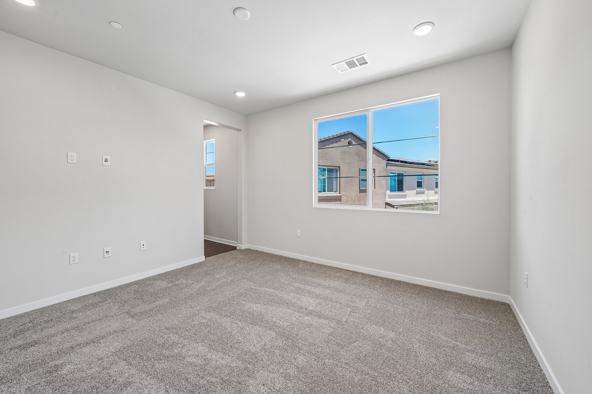 A room with a window and a door.