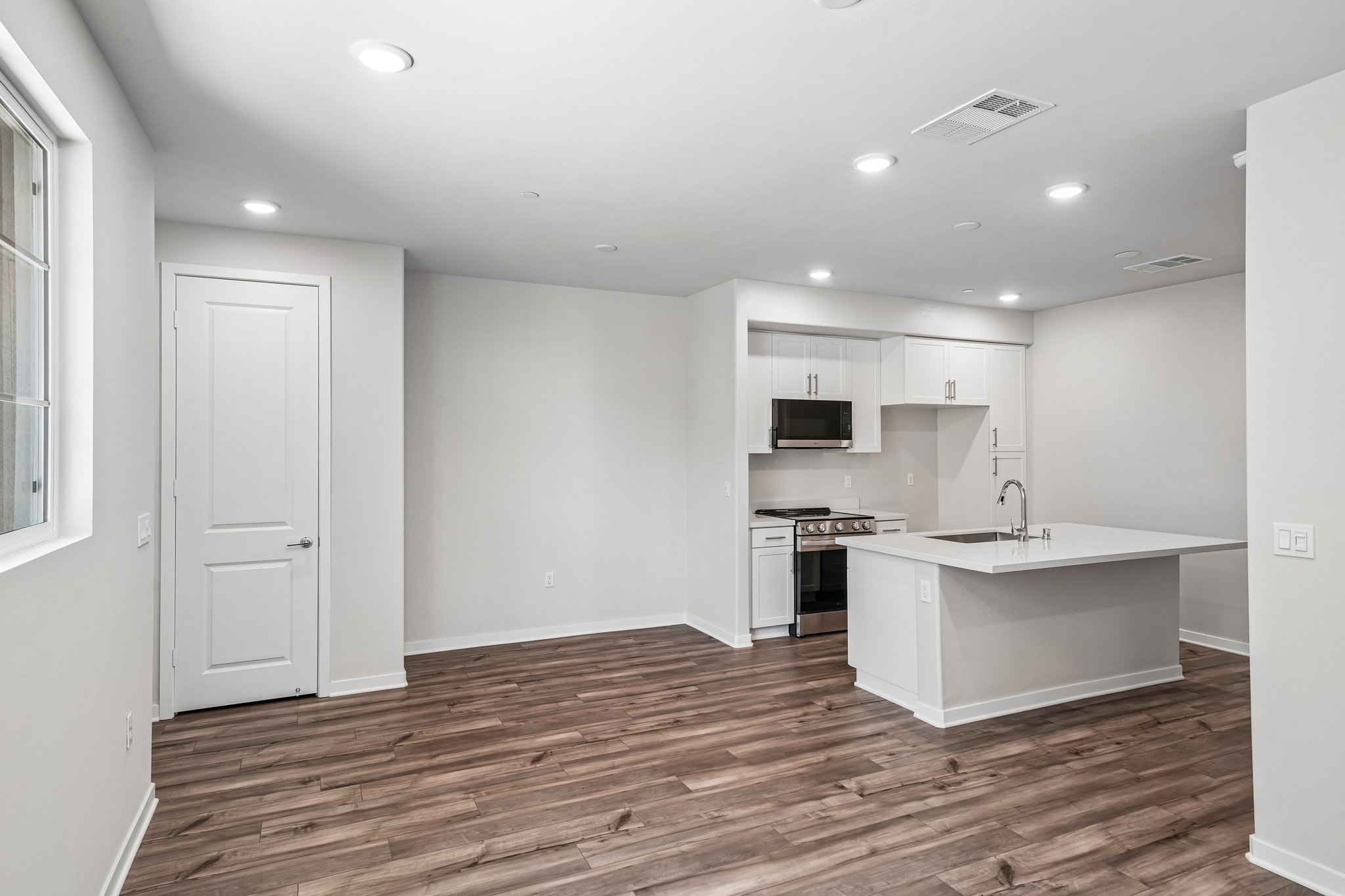 A kitchen with white cabinets.