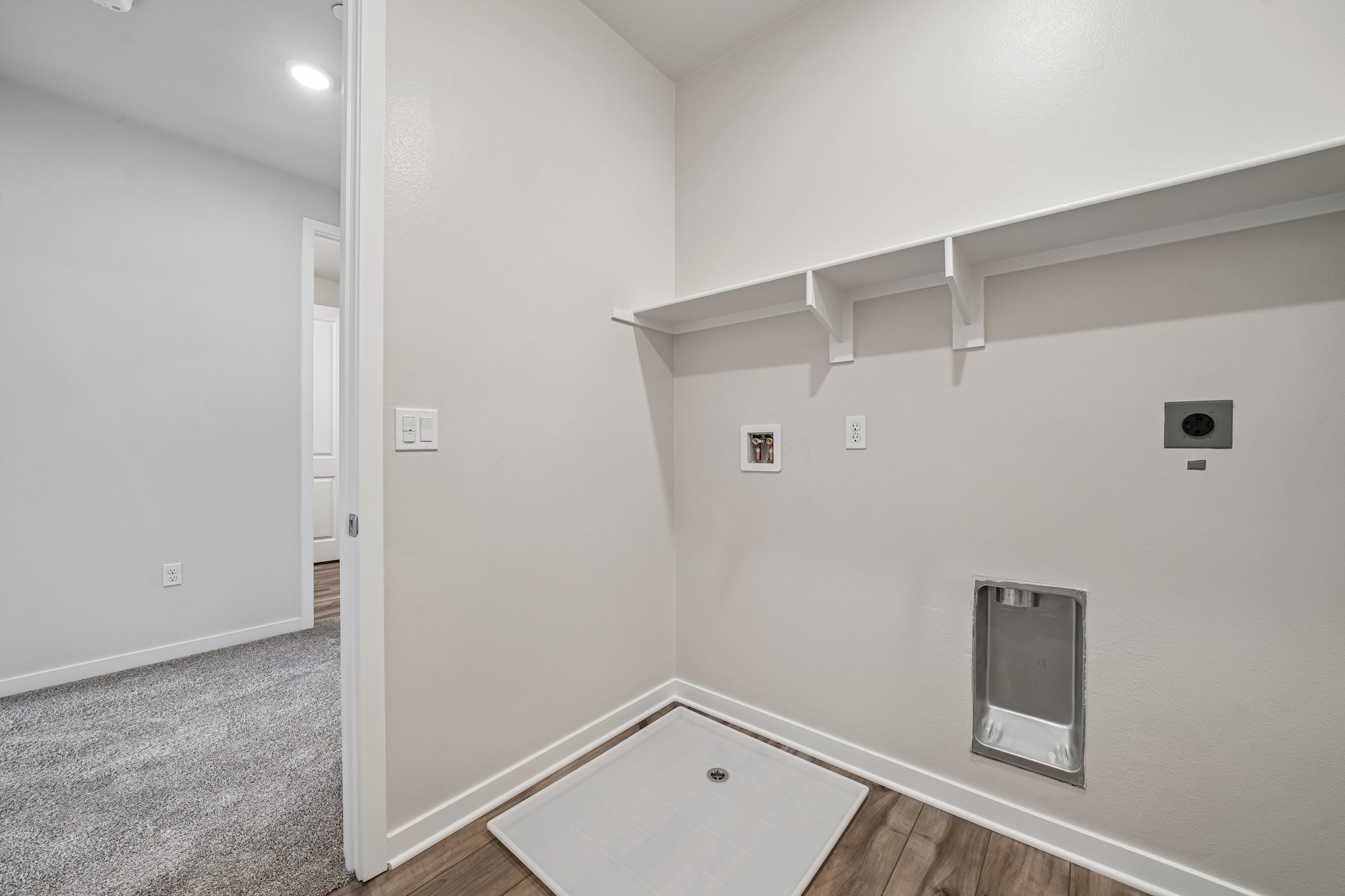 A bathroom with a sink and a shower unit.
