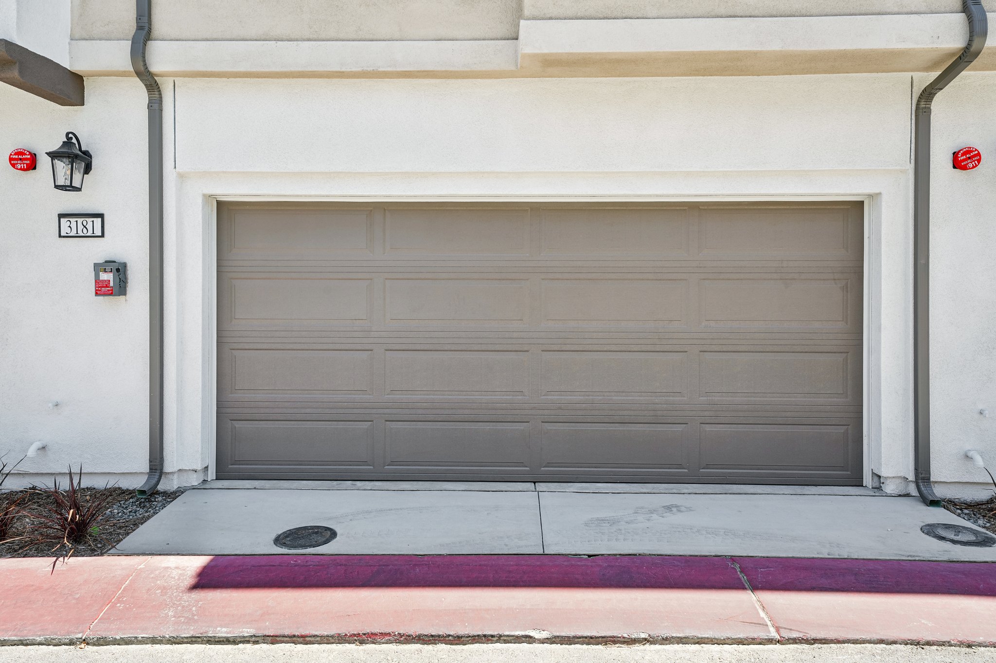 A garage door with a red light.