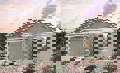 A house with a gravel driveway.