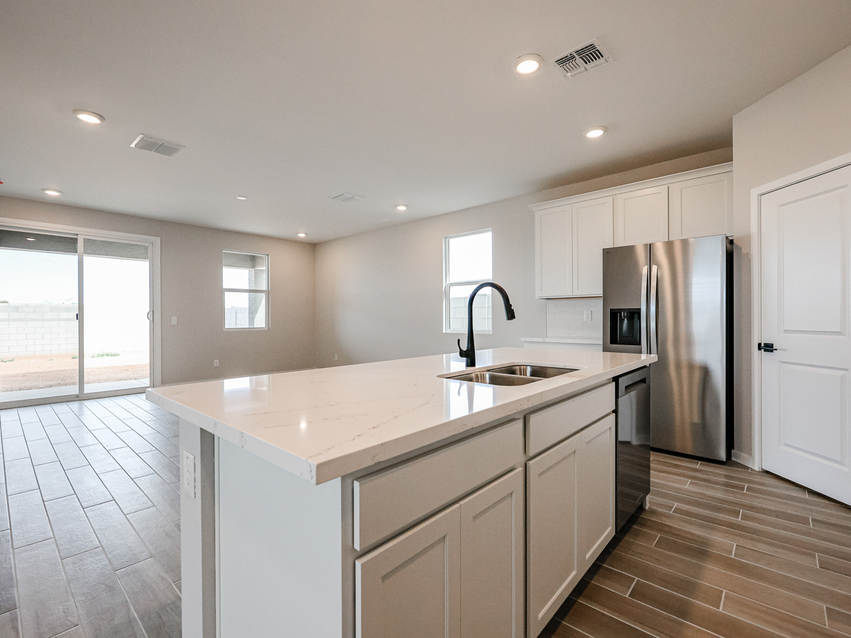 A kitchen with white cabinets.