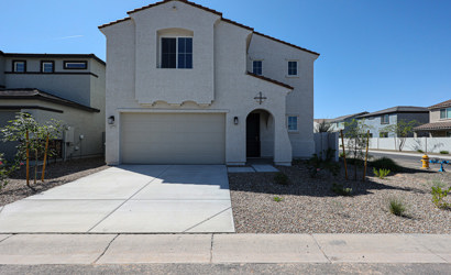 A white building with a garage.