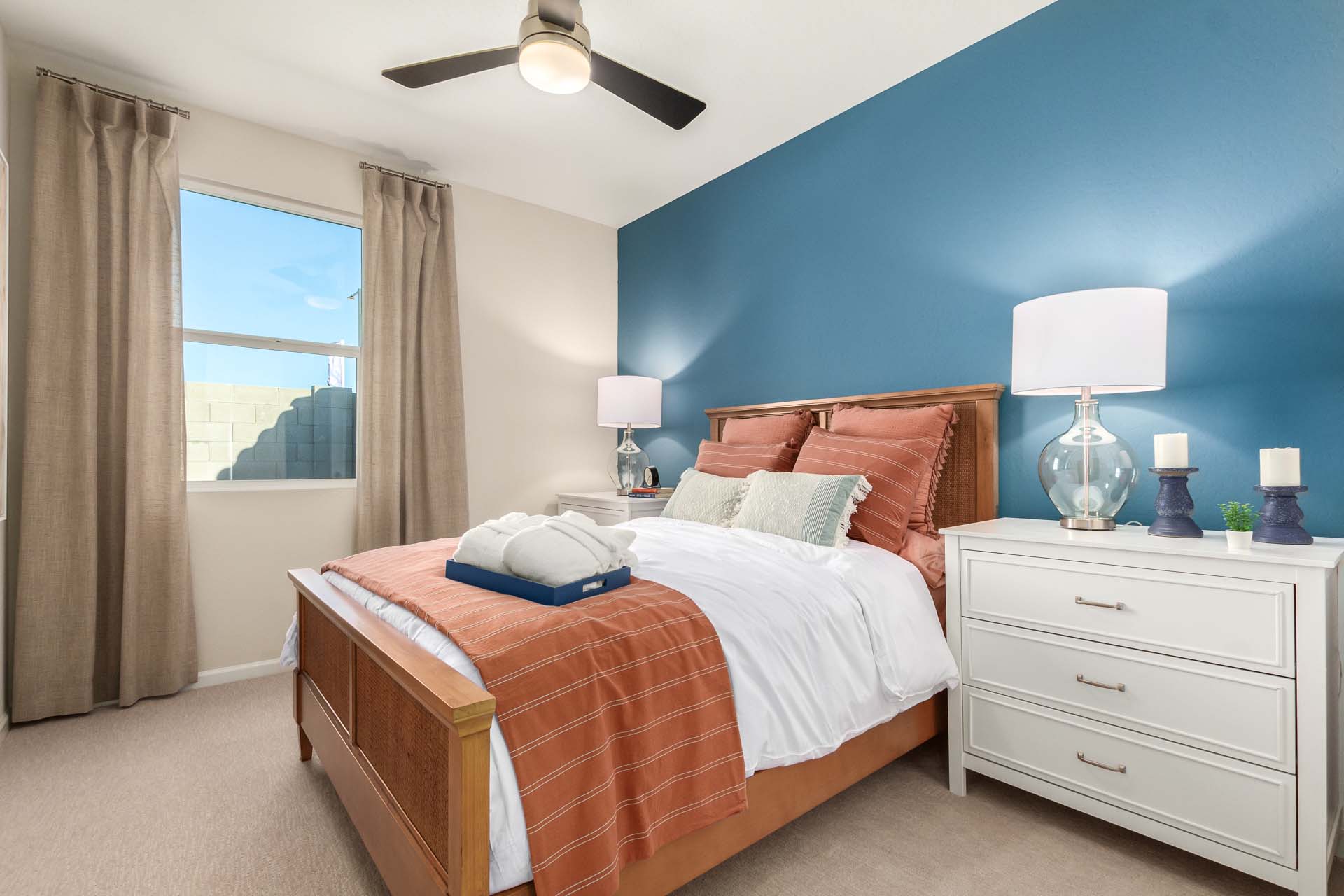 A bedroom with a large window.