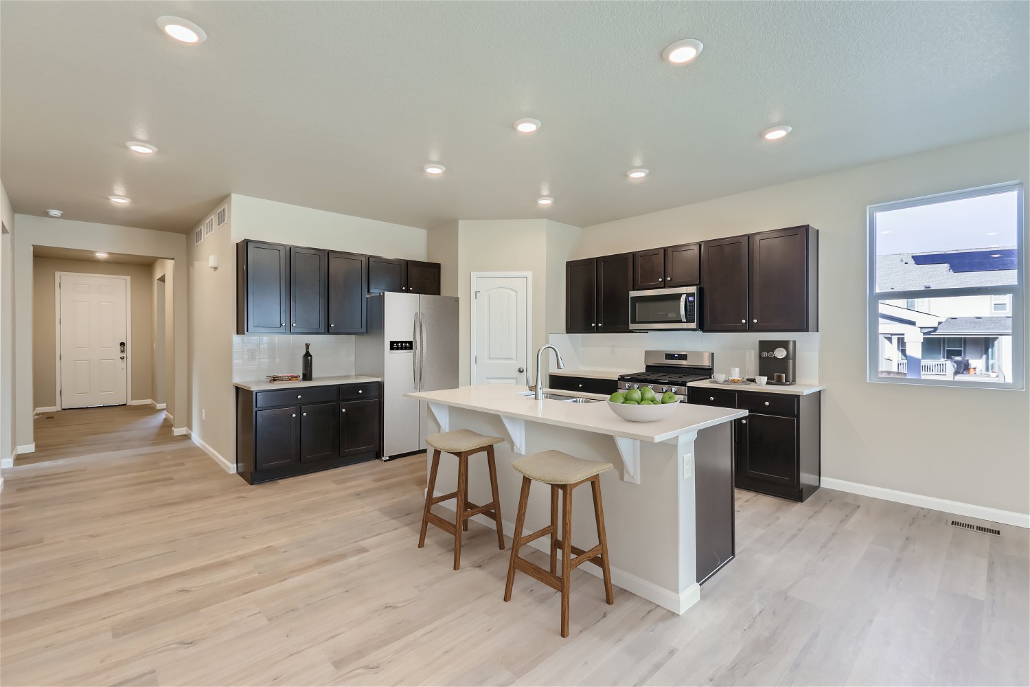 A kitchen with black cabinets.
