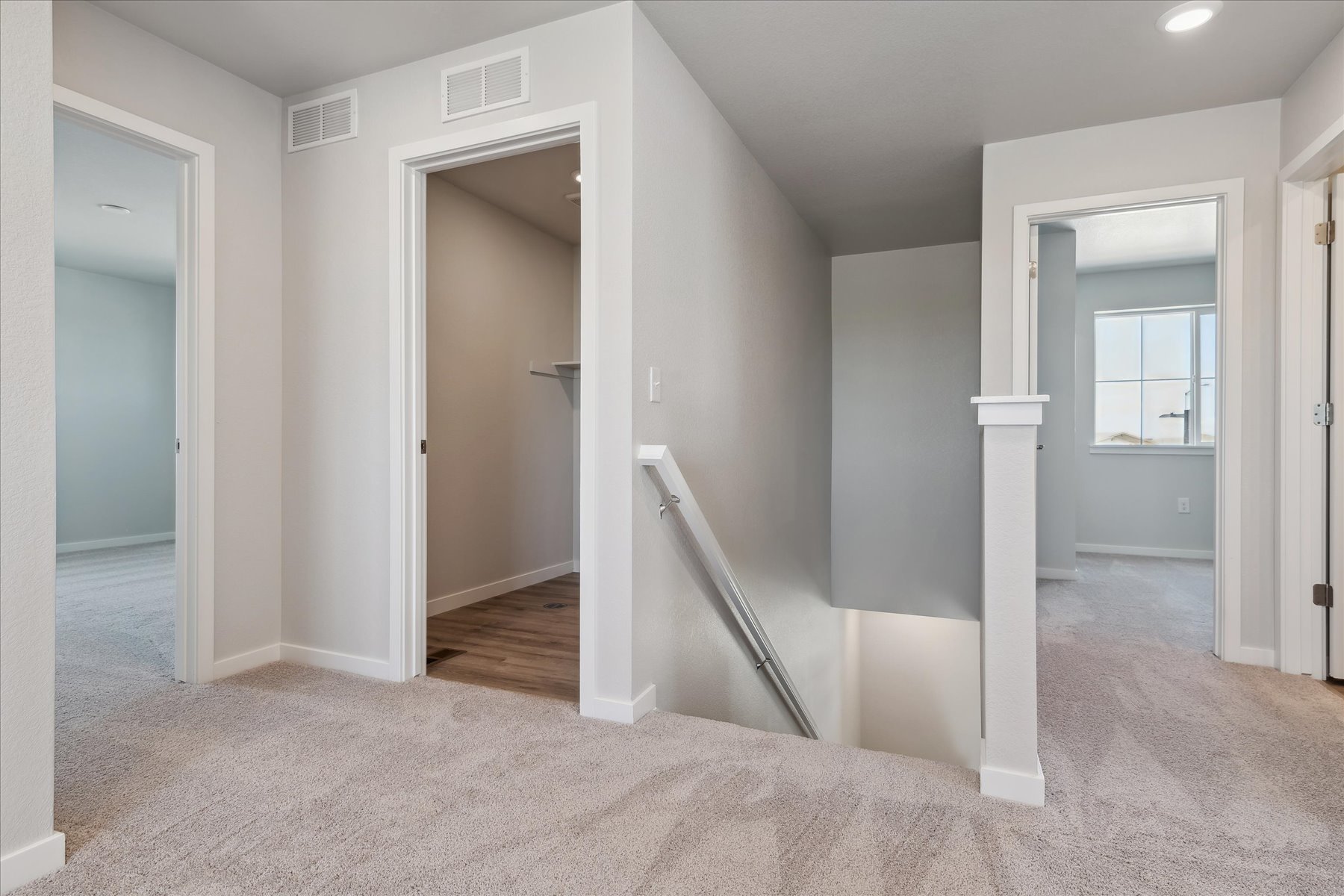 A room with a staircase and a door.