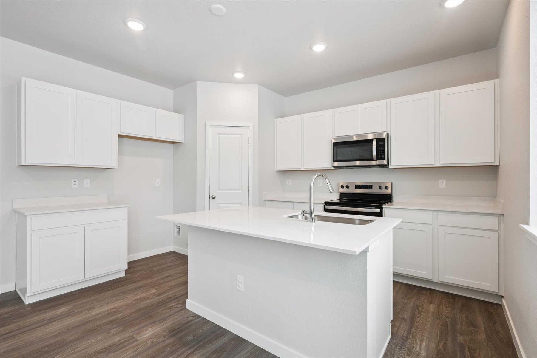 A kitchen with white cabinets.