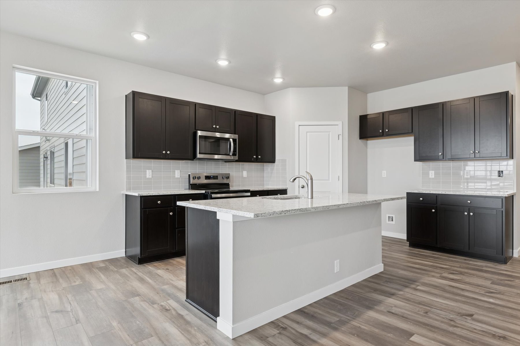 A kitchen with black cabinets.