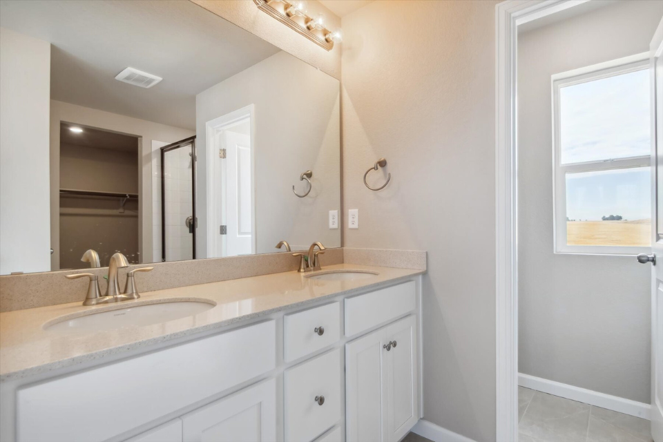 A bathroom with a large mirror.