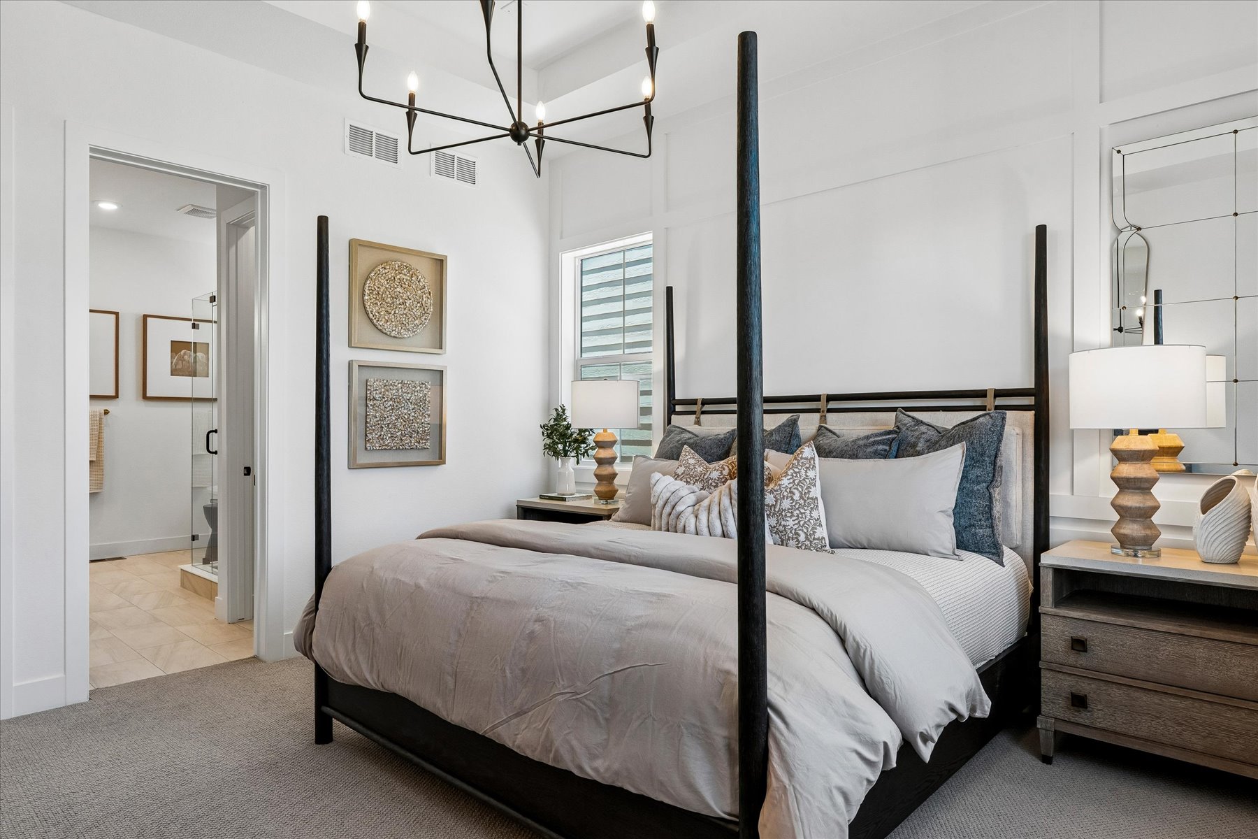 A bedroom with a bed and lamps.