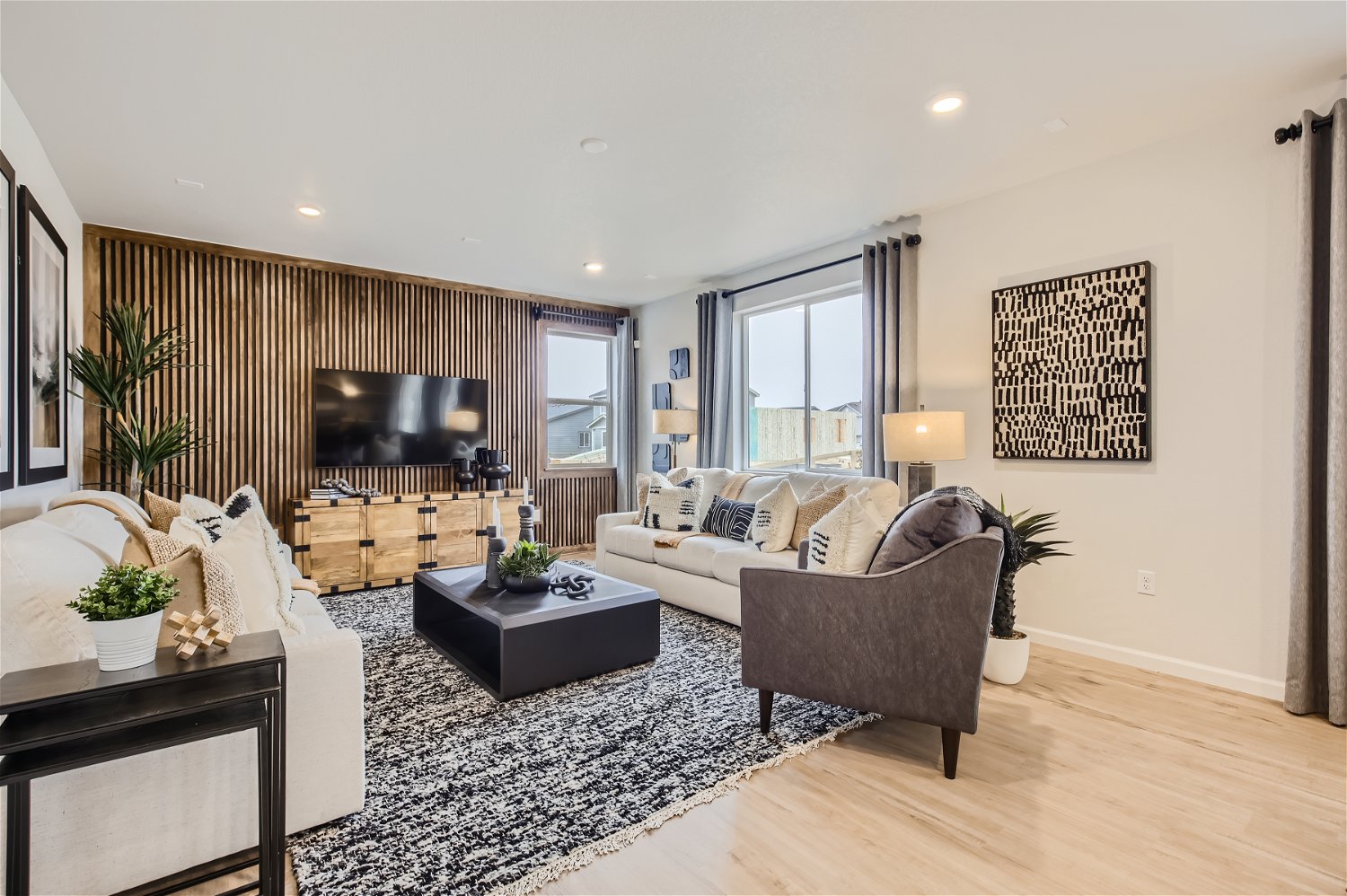 A living room with a large tv and couches.