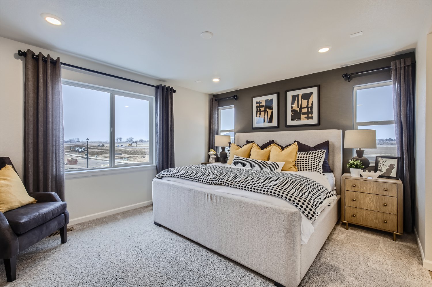 A bedroom with a large window.