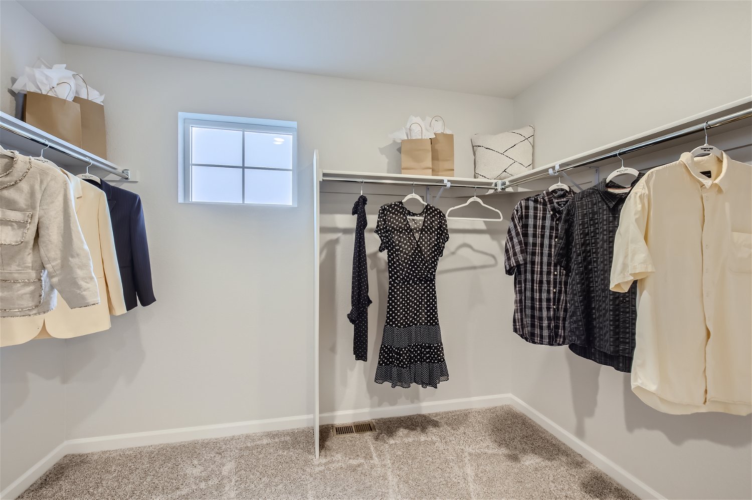 A room with a rack of clothes.