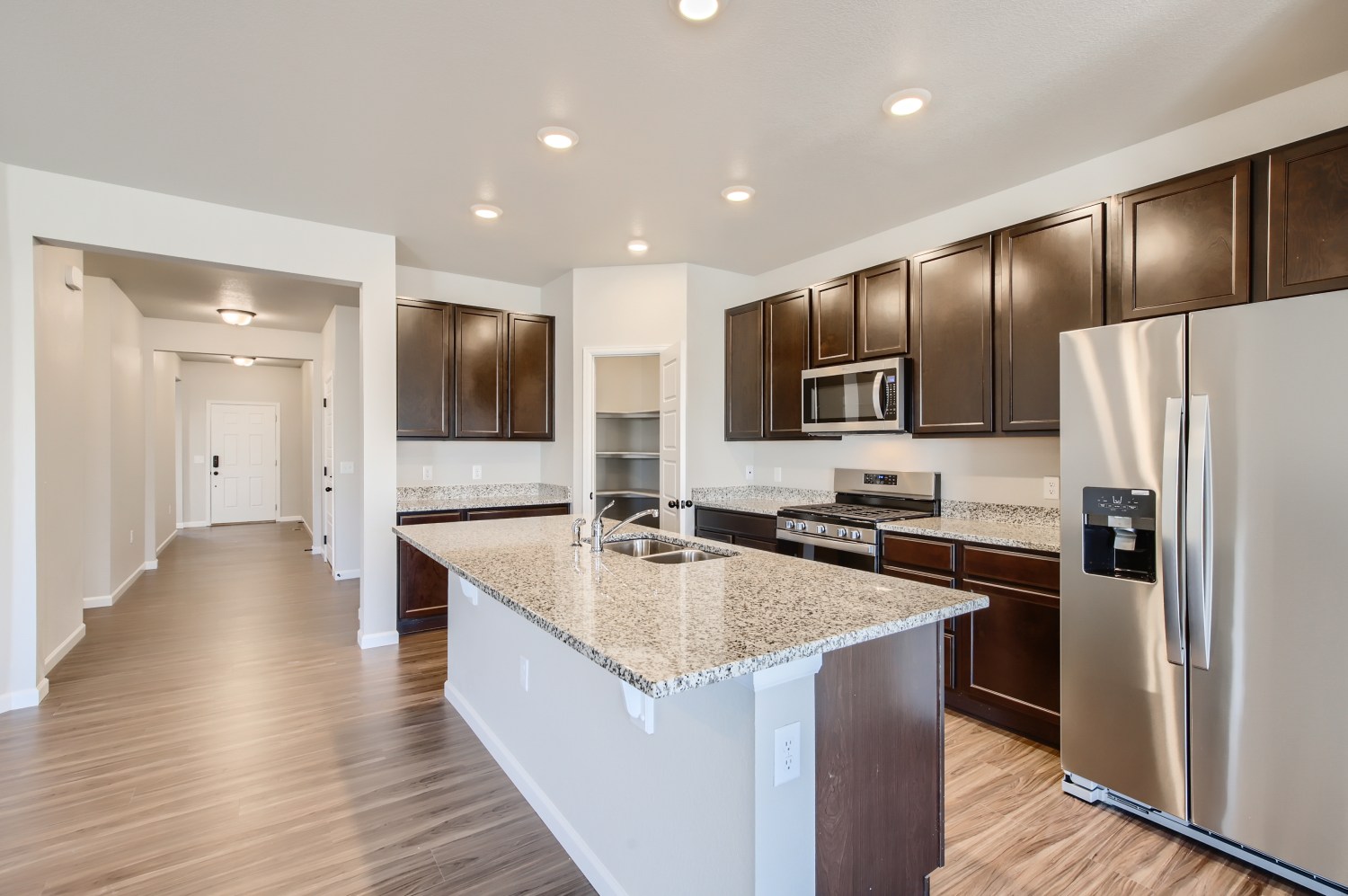 A kitchen with a marble counter top.