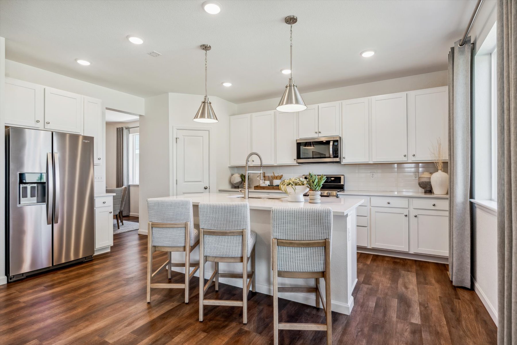 A kitchen with white cabinets.