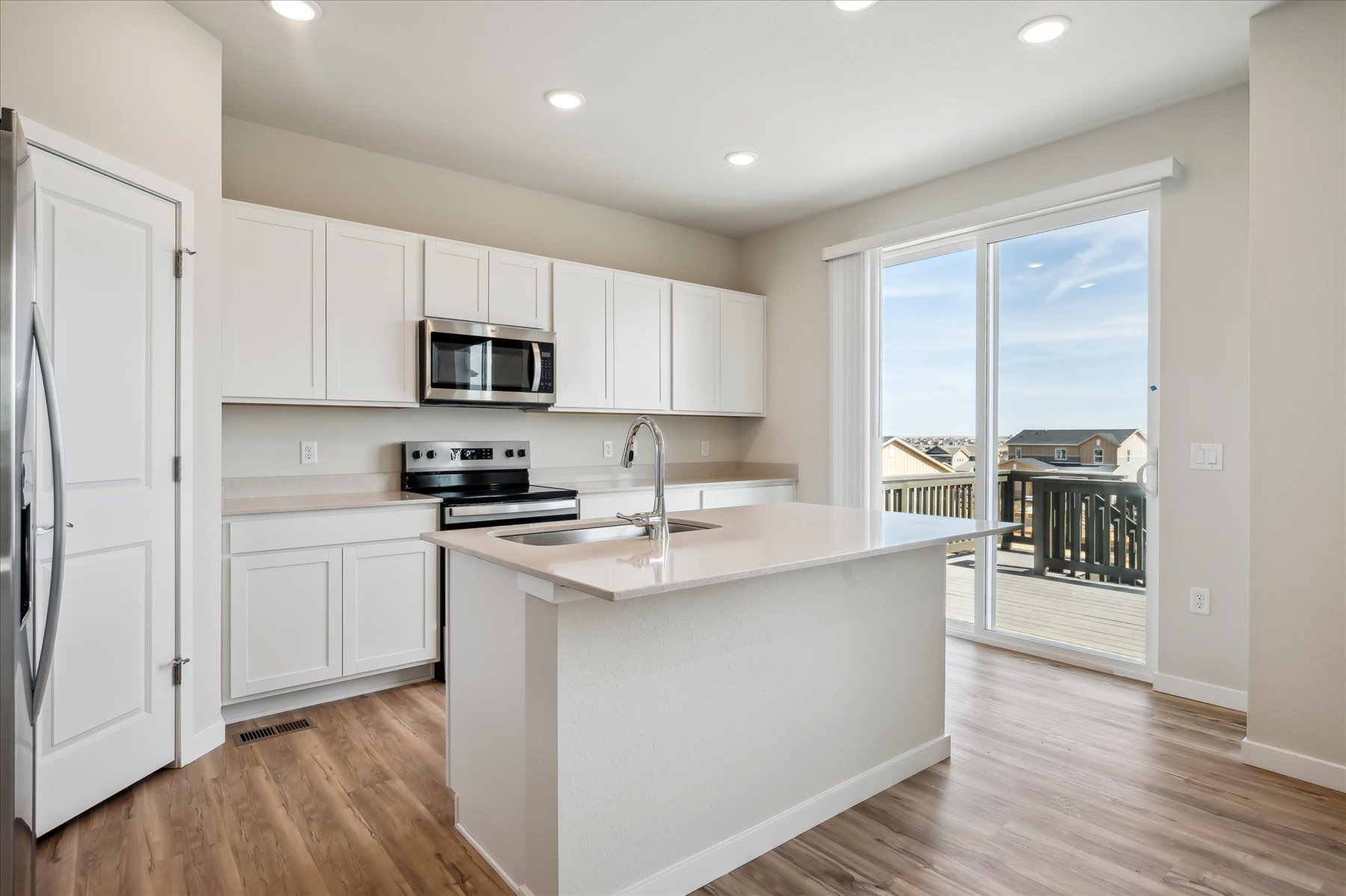 A kitchen with white cabinets.