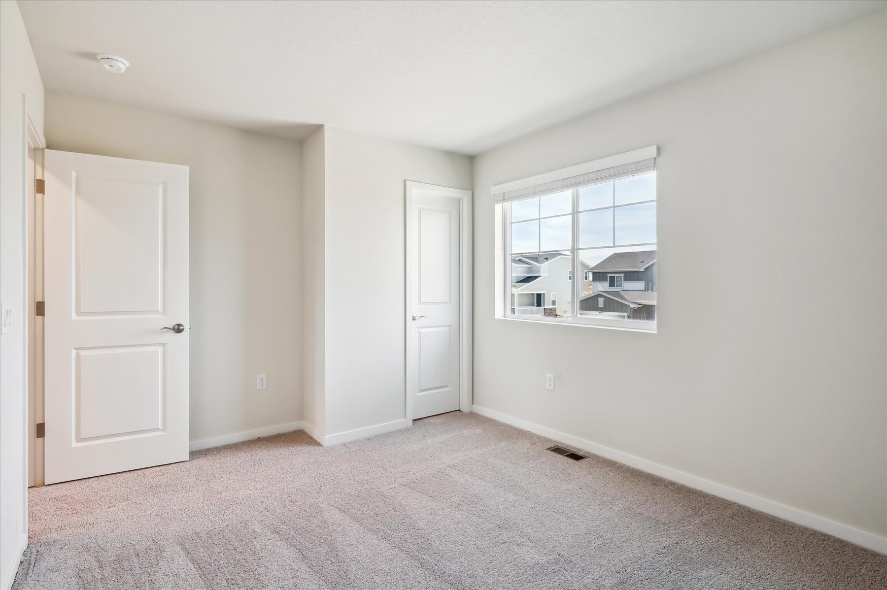 A room with white walls and a window.