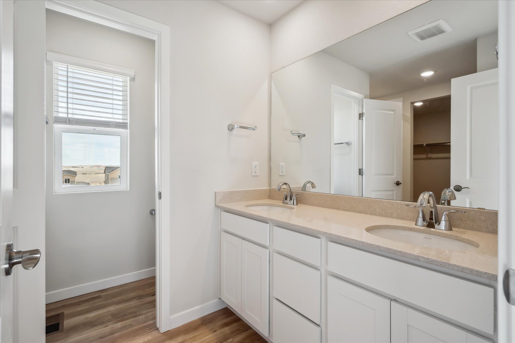 A bathroom with white cabinets.