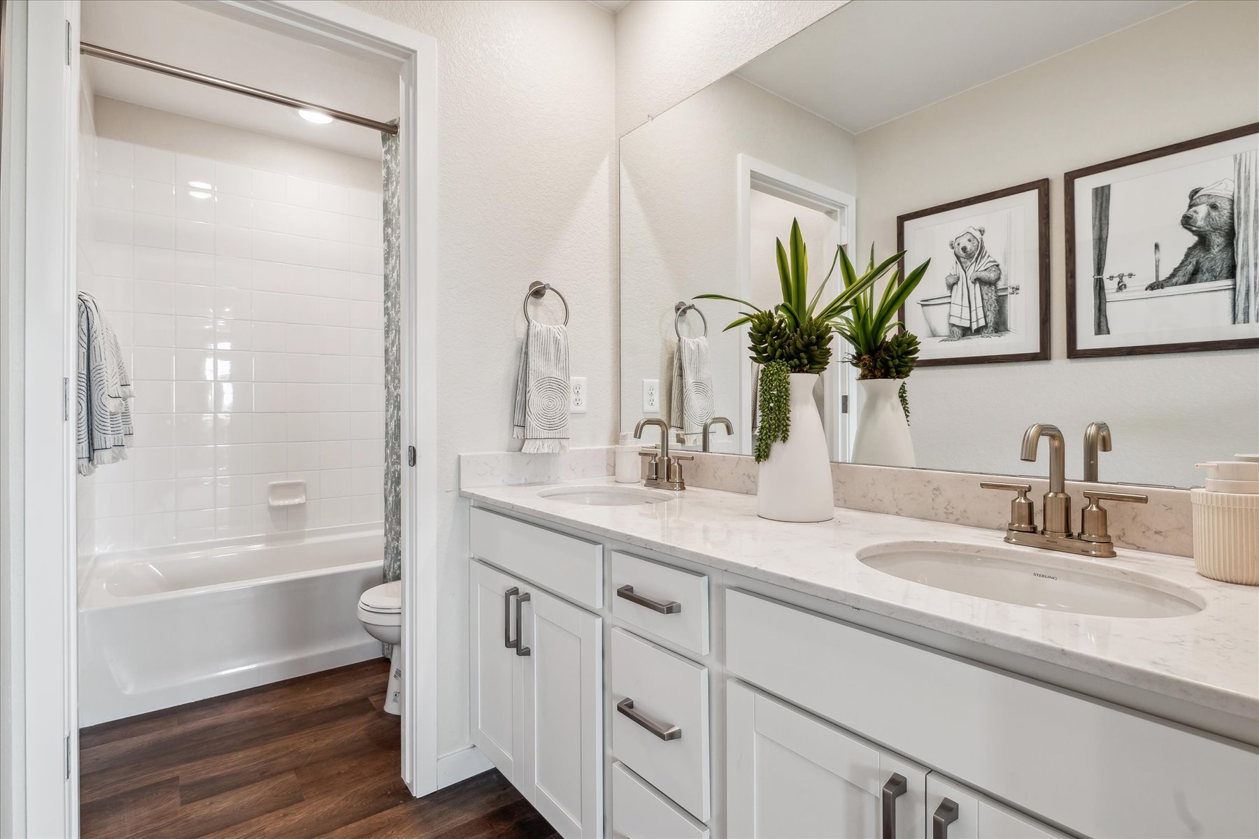 A bathroom with a tub sink and toilet.