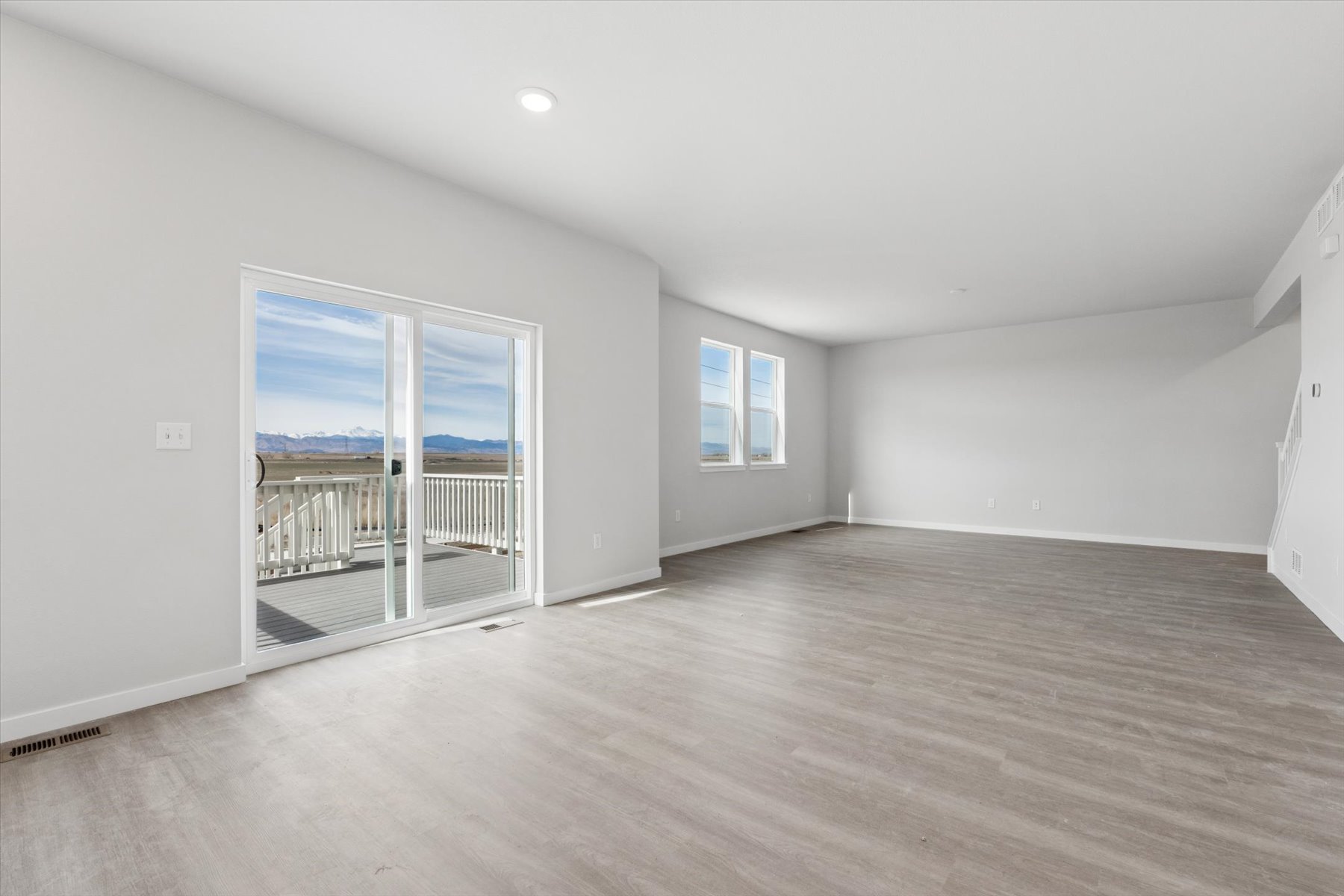 A room with a wood floor and a wood floor with a window.