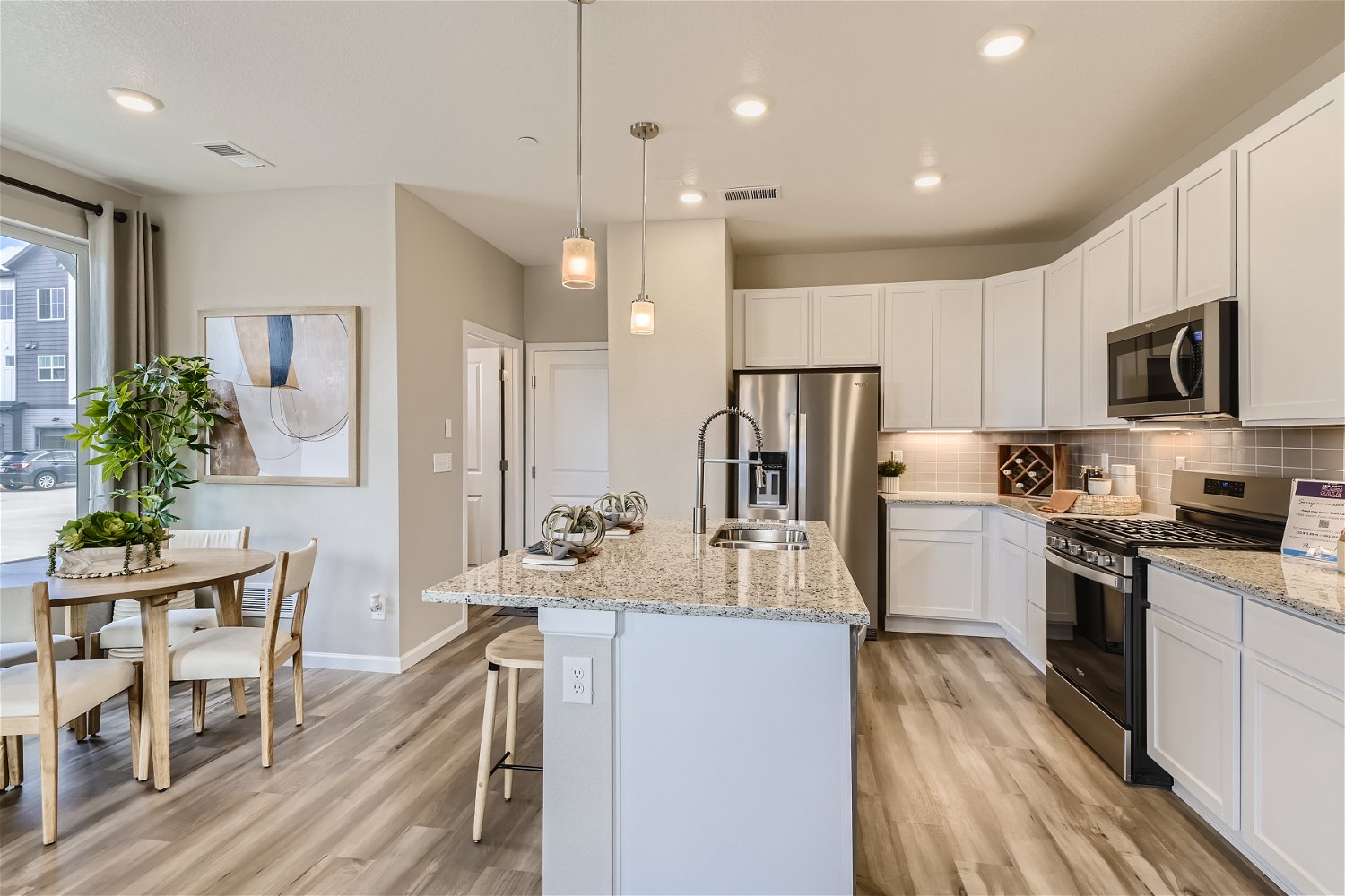 A kitchen with white cabinets.