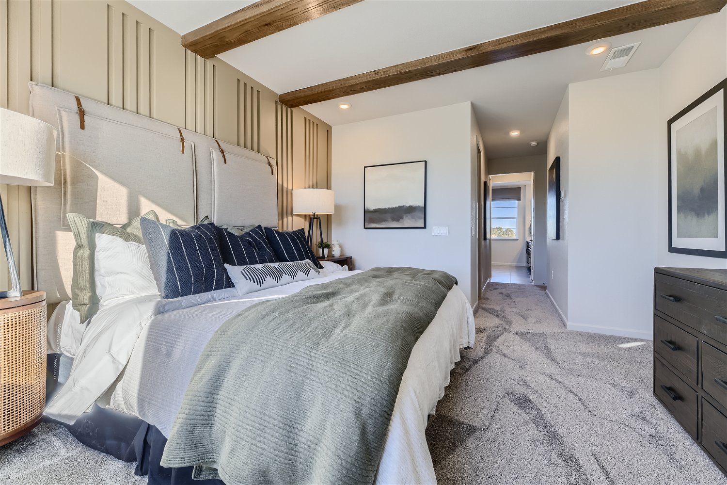A bedroom with a bed and lamps.