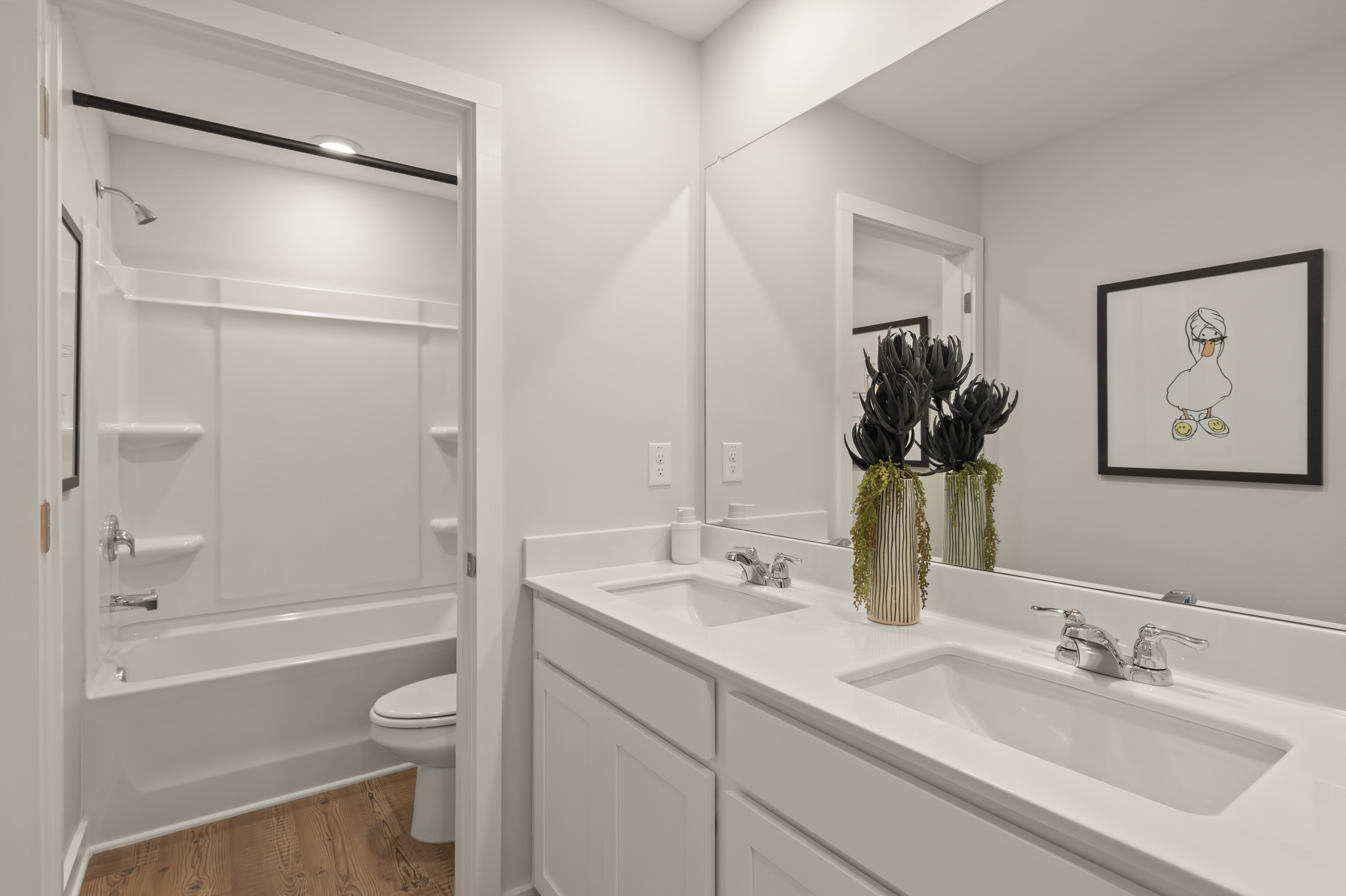 A bathroom with a sink toilet and a shower.