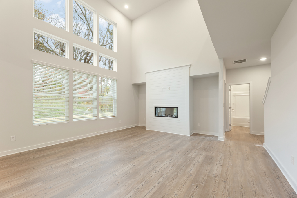 A room with a fireplace and a wood floor.
