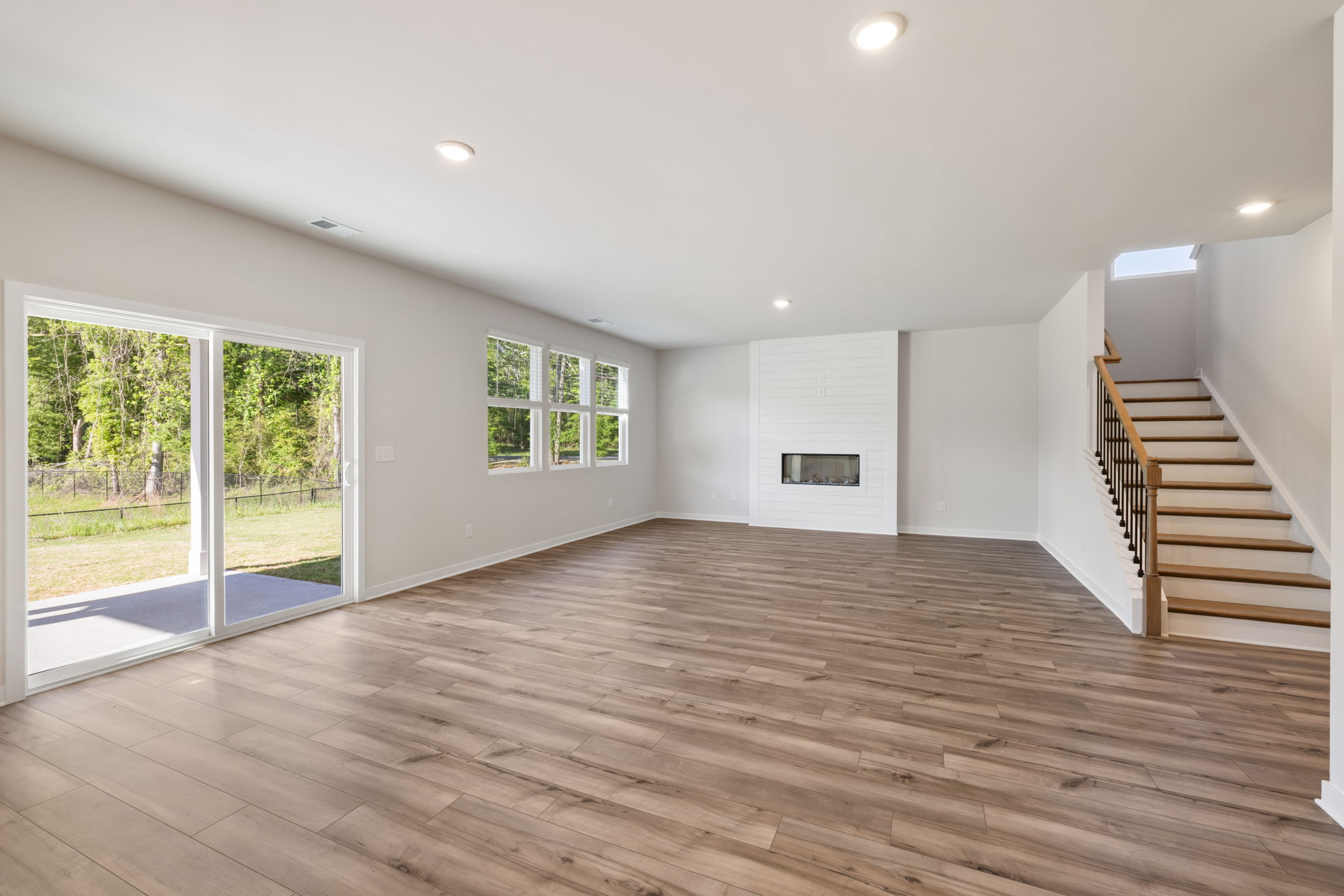 A large room with a wood floor and a wood floor.