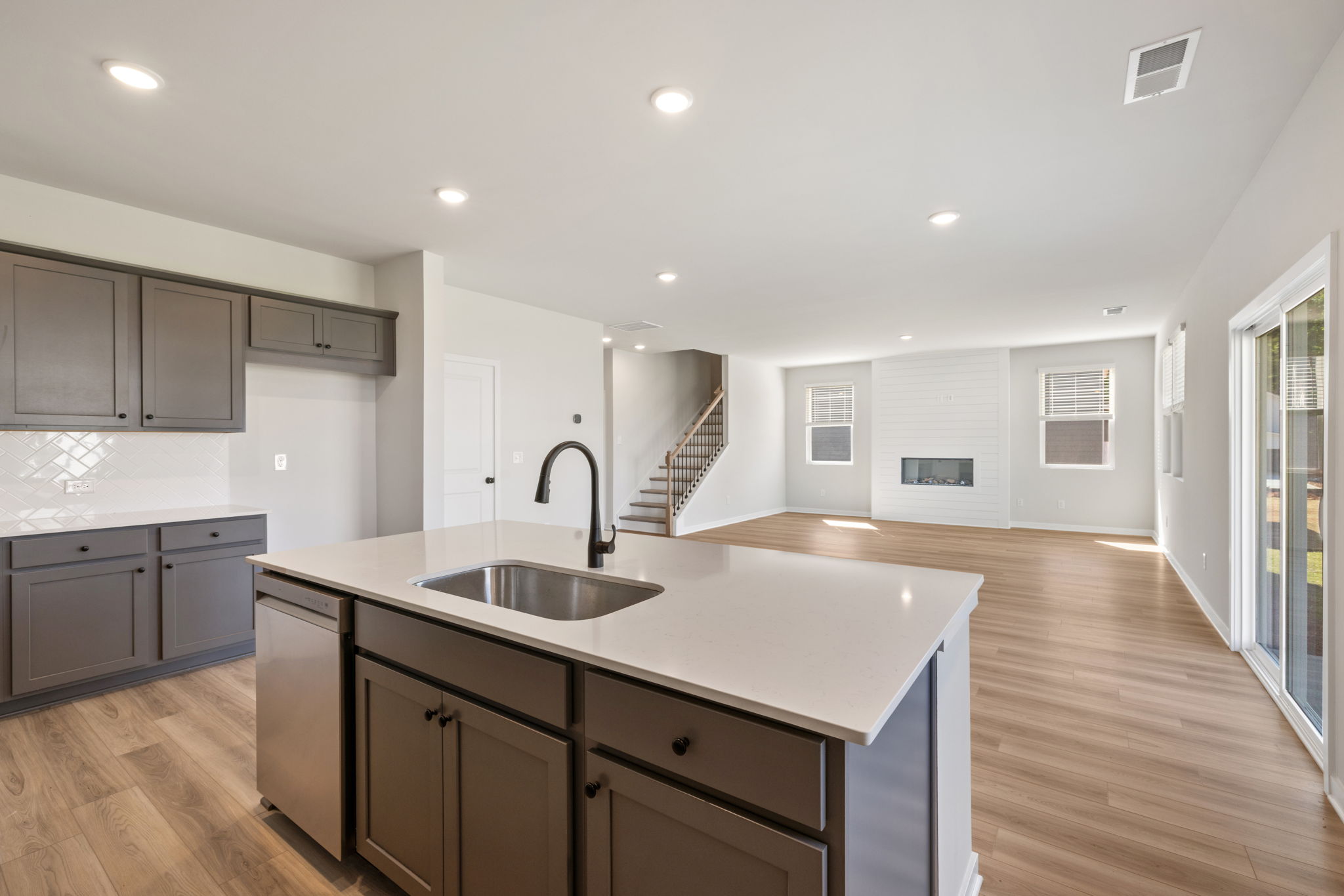 A kitchen with a wood floor.