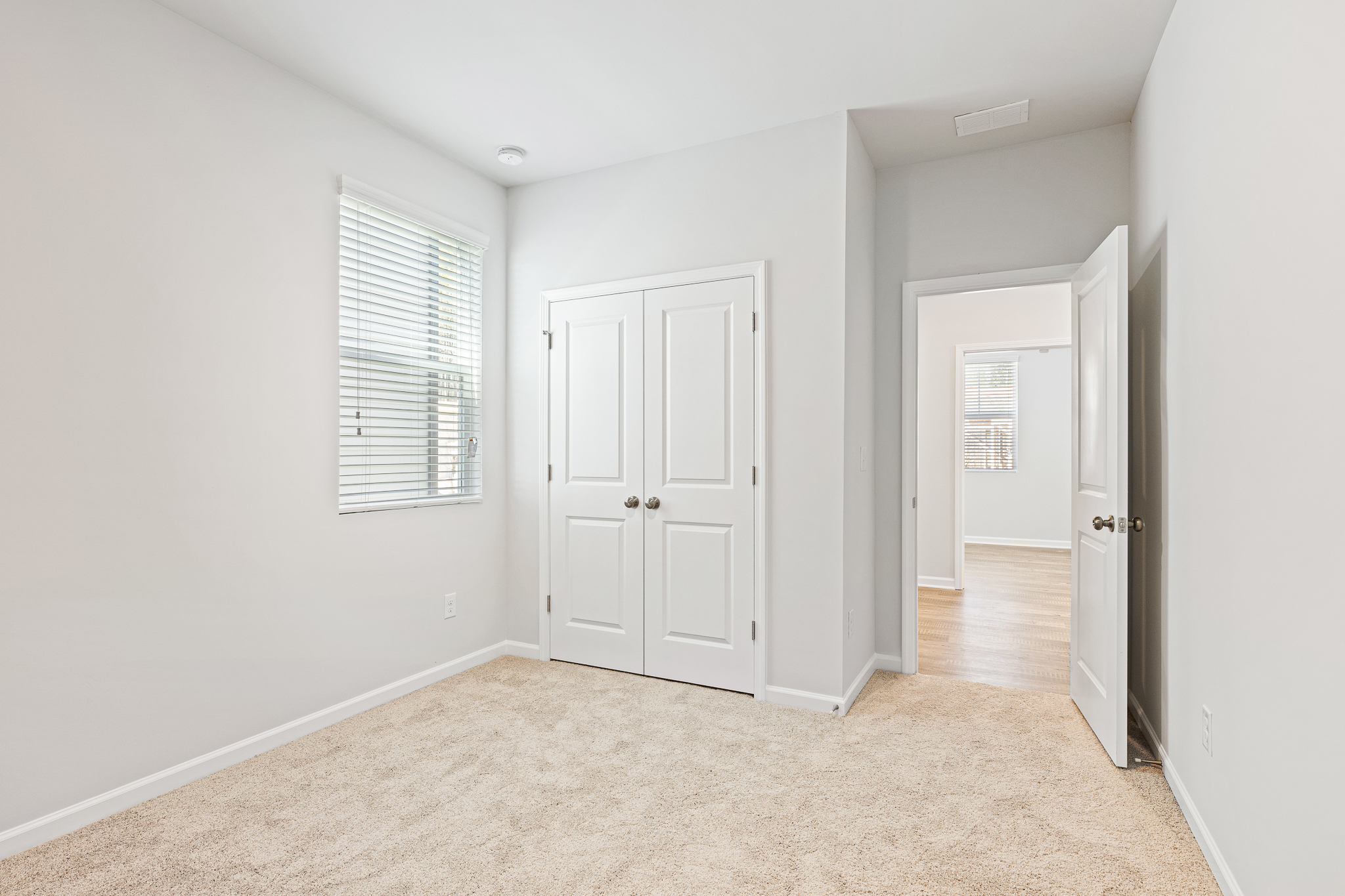 A hallway with white doors.