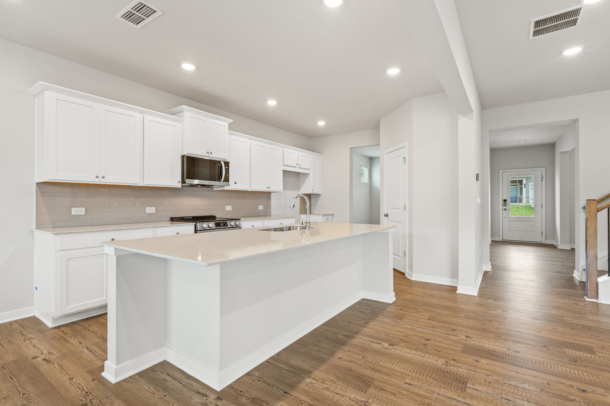 A kitchen with white cabinets.