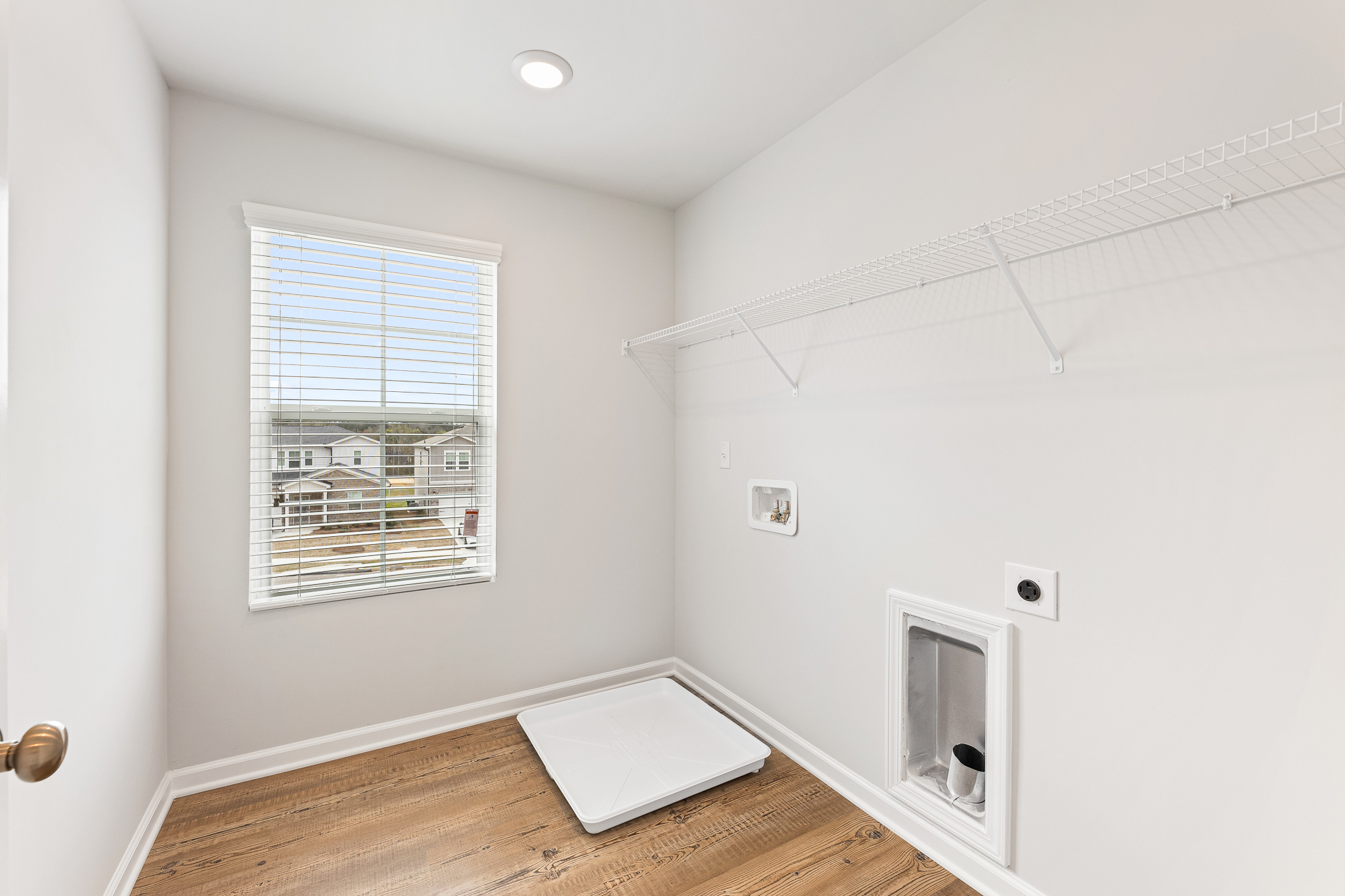 A room with a window and a rug.
