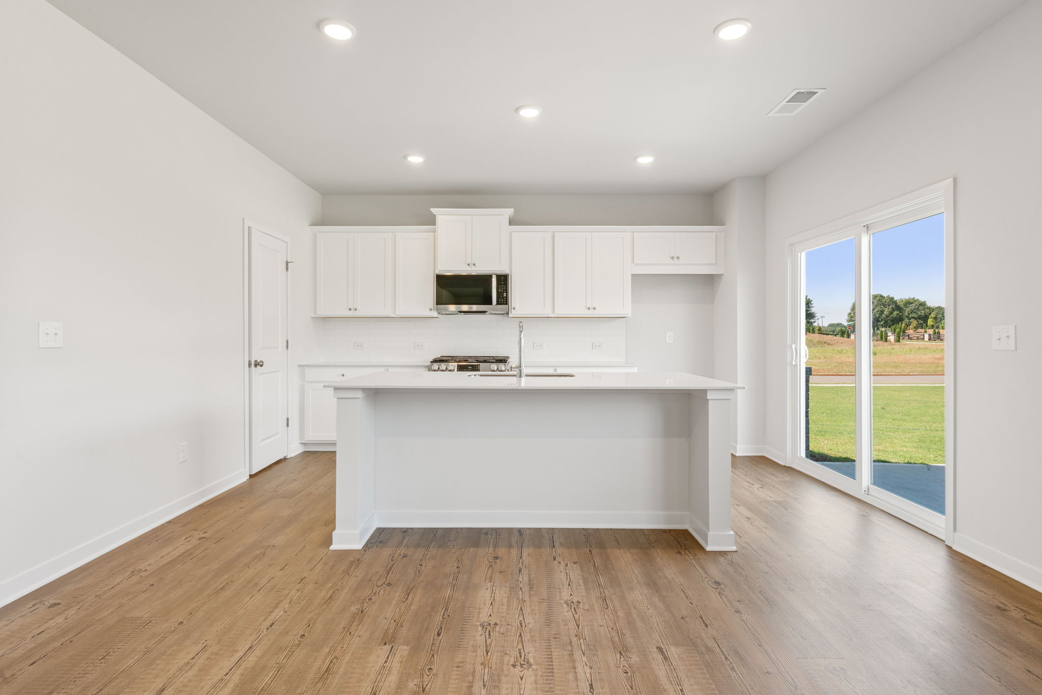 A kitchen with white cabinets.