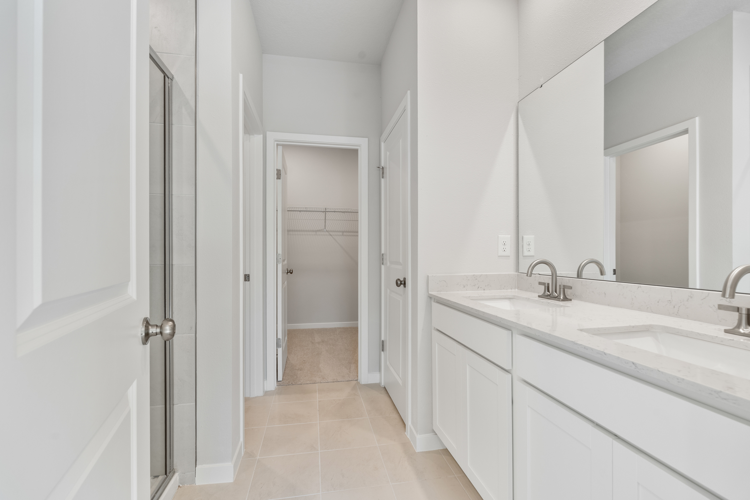 Lot 151 Primary Bathroom with Dual Sinks and Shower at Seminole Palms