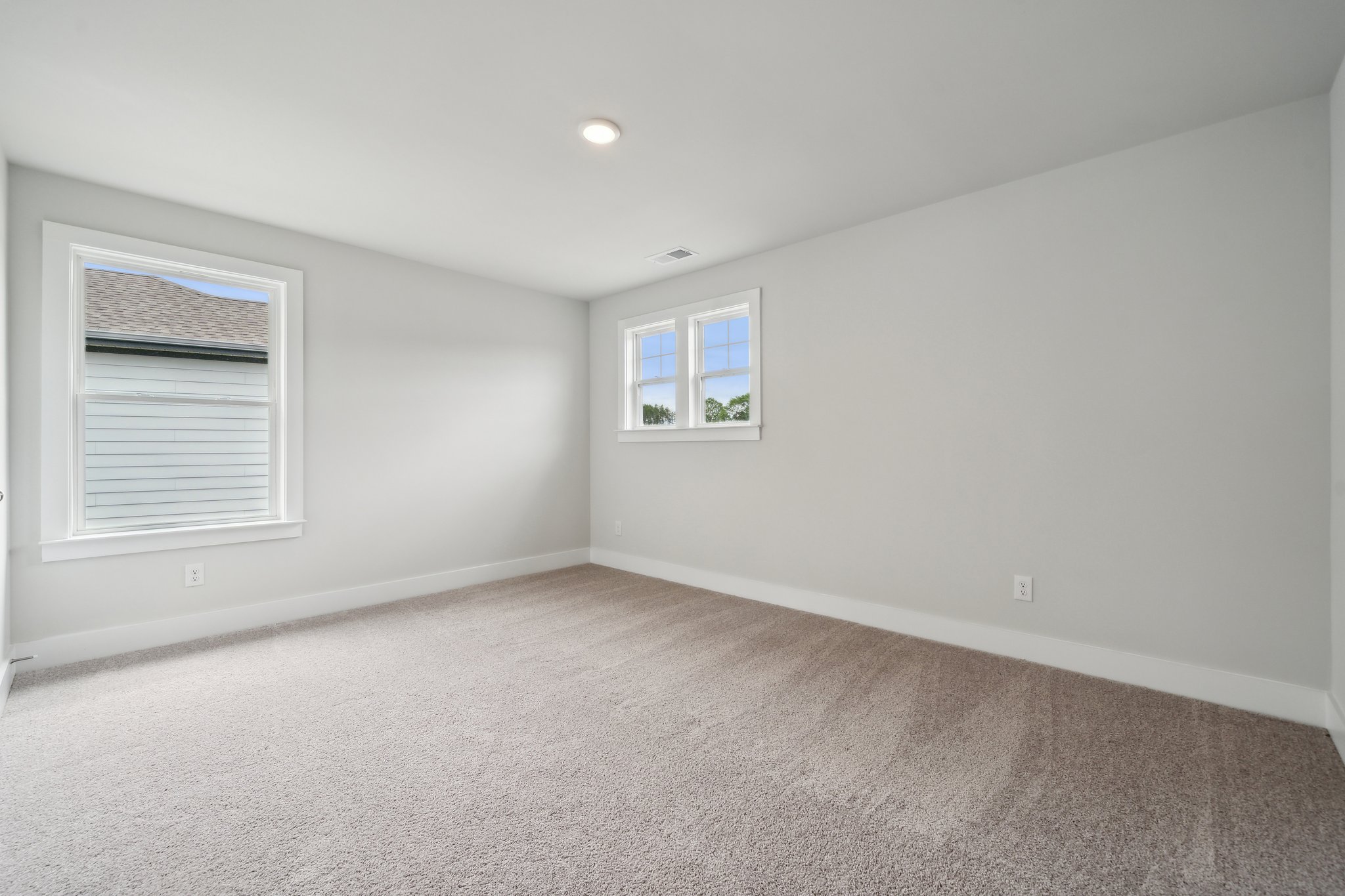 A room with a window and a carpet.