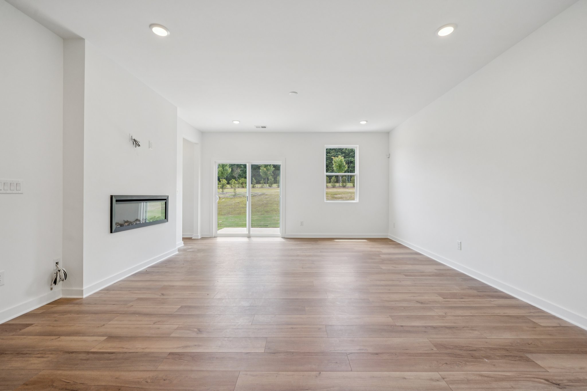 A room with white walls and a wood floor.