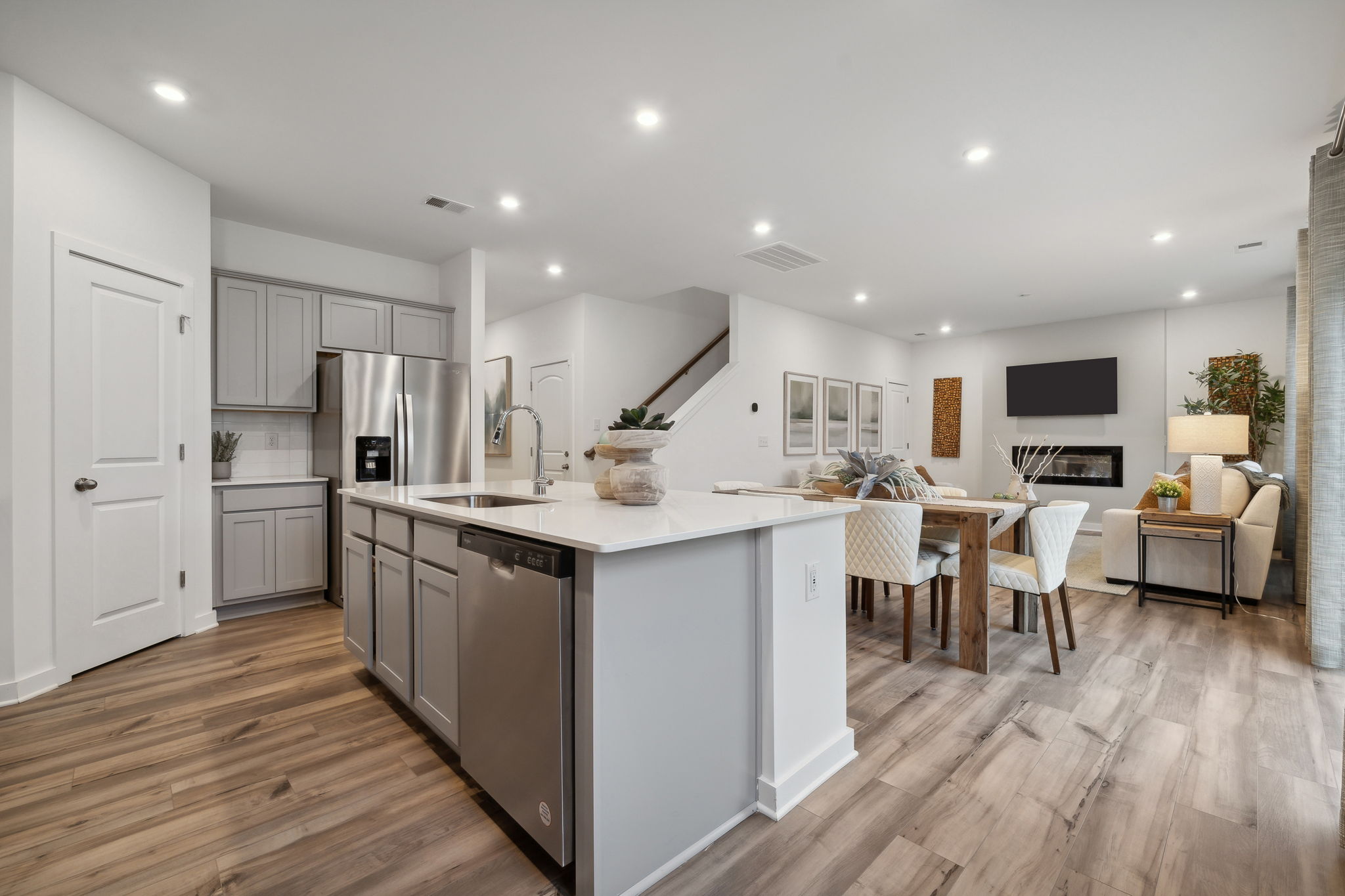A kitchen with white cabinets.