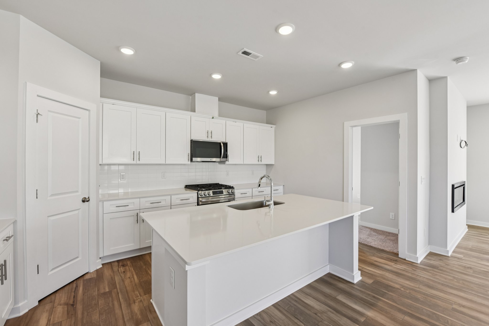 A kitchen with white cabinets.