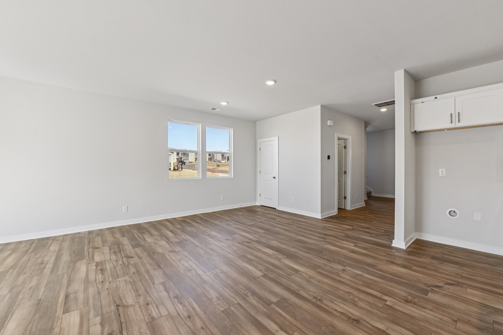 A room with a wood floor and white walls.
