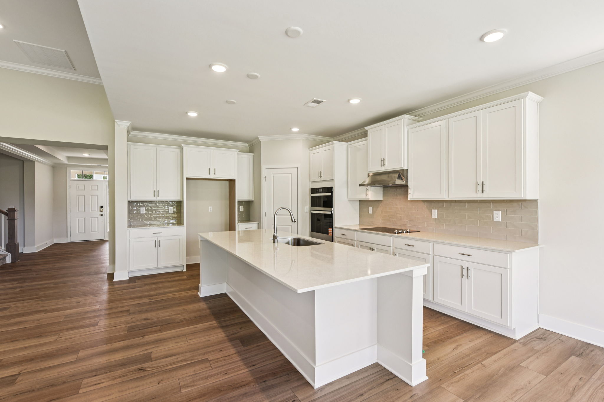 A kitchen with white cabinets.