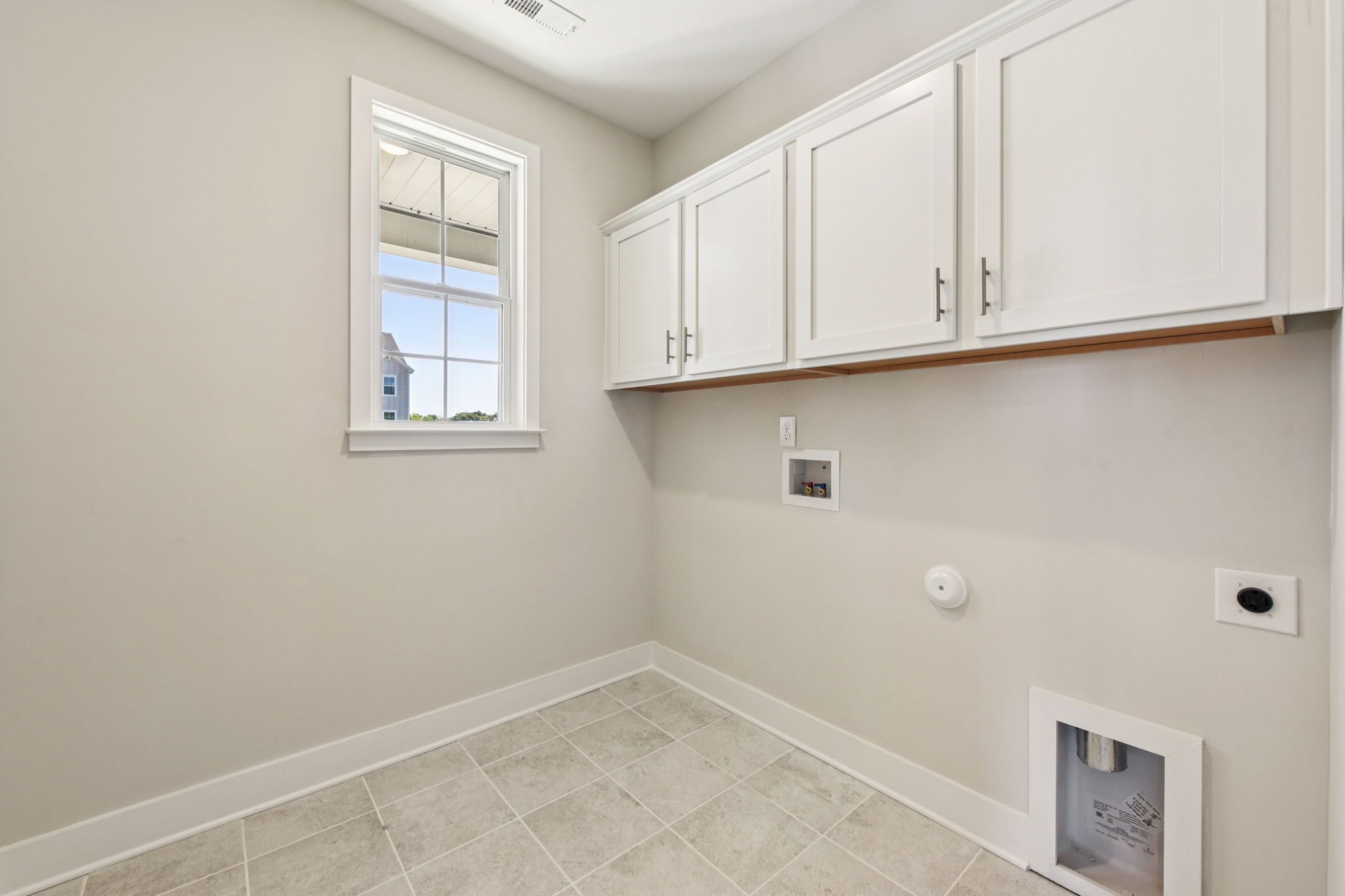 A white kitchen with white cabinets.